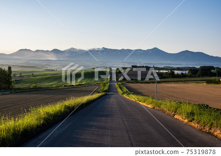 Scenery of Kamifurano Town and Tokachidake Mountain Range in summer Scenery of Kamifurano Town and Tokachidake Mountain Range in summer 75319878