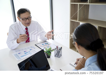 Diverse male mentor and intern talking pointing on paper 75320197