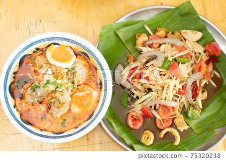 Spicy Papaya Salad raw prawn spice on banana leafand Tomyum Spicy Papaya Salad raw prawn spice on banana leafand Tomyum 75320238
