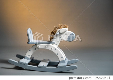Handmade rocking horse on a gray background 75320521