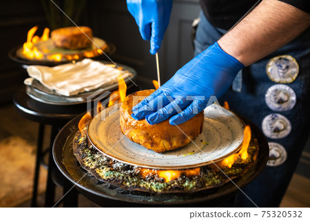 Shah's pilaf. Serving and cutting Khan's pilaf in lavash in Azerbaijani style in the restaurant. Traditional Oriental dish Shah's pilaf. Serving and cutting Khan's pilaf in lavash in Azerbaijani style in the restaurant. Traditional Oriental dish 75320532