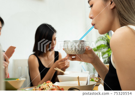 Woman eats fresh ice water after zip spicy hot tomyum soup Woman eats fresh ice water after zip spicy hot tomyum soup 75320554