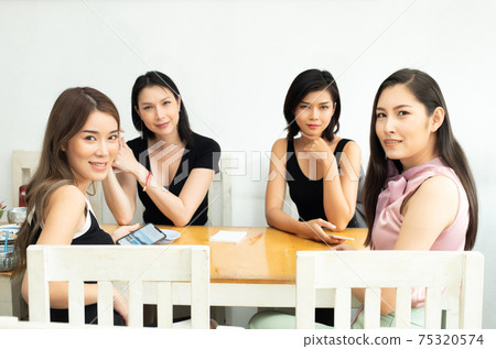 Four Asian Woman sit in Cafe for Lunch near windows Four Asian Woman sit in Cafe for Lunch near windows 75320574