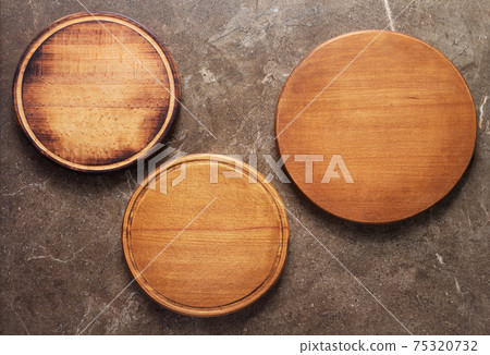 Pizza or bread cutting board for homemade baking on table. Food recipe concept Pizza or bread cutting board for homemade baking on table. Food recipe concept 75320732