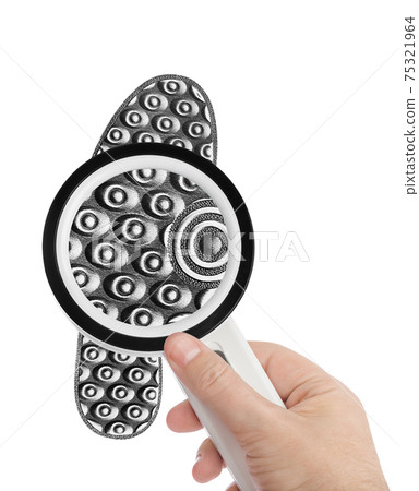 Magnifying glass in hand and shoe printout 75321964