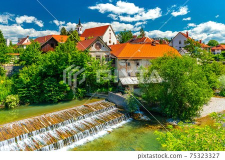 A small waterfall in the ancient Slovenian town Skofja Loka 75323327