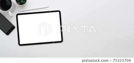 Horizontal photo of mock up digital tablet, smartphone, coffee cup and copy space on white background. Horizontal photo of mock up digital tablet, smartphone, coffee cup and copy space on white background. 75323704