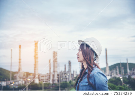 Woman engineer entrepreneur construction industry worker. Female engineer working refinery oil plant manufacturing. Young civil engineering construction wear hard hat safety helmet construction site. 75324289