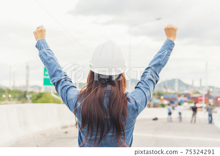 Woman engineer entrepreneur construction industry worker. Female engineer working refinery oil plant manufacturing. Young civil engineering construction wear hard hat safety helmet construction site. 75324291