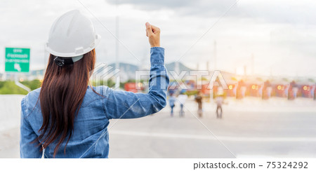 Woman engineer entrepreneur construction industry worker. Female engineer working refinery oil plant manufacturing. Young civil engineering construction wear hard hat safety helmet construction site. 75324292