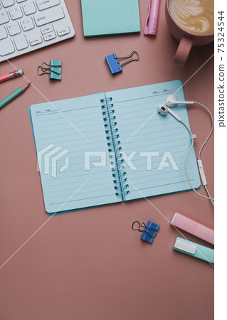 Above view of empty notebook and stationery on pink pastel background. Above view of empty notebook and stationery on pink pastel background. 75324544