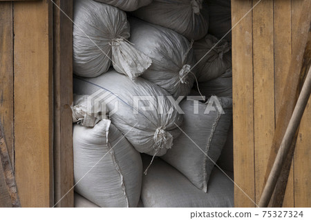 large bales of straw lie under a canopy from the rain large bales of straw lie under a canopy from the rain 75327324