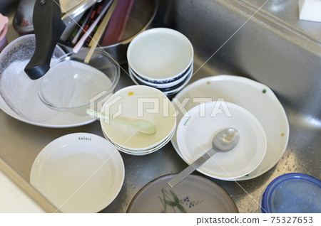 Unwashed dishes that have accumulated Unwashed dishes that have accumulated 75327653