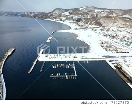 Aerial view of the snow scene of Toyoura fishing port in Toyoura-cho, Hokkaido in early spring Aerial view of the snow scene of Toyoura fishing port in Toyoura-cho, Hokkaido in early spring 75327870