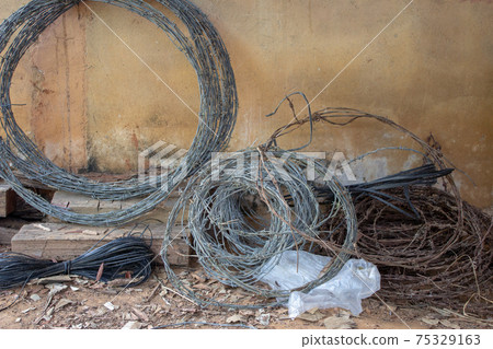 Rolls of used barbed wire used for building cattle fences Rolls of used barbed wire used for building cattle fences 75329163