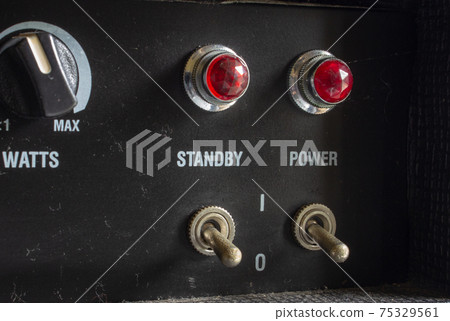 Buttons, knobs and lights of a guitar amplifier Buttons, knobs and lights of a guitar amplifier 75329561
