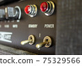 Buttons, knobs and lights of a guitar amplifier 75329566