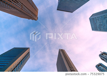 Tokyo cityscape of Japan View of Shinjuku skyscrapers and aircraft (Tokyo Metropolitan Government Building at the bottom right of the screen) 75329875