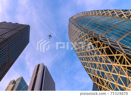 View of Tokyo cityscape of Japan, such as the skyscrapers of Shinjuku and aircraft (the right side of the screen is Mode Gakuen Cocoon Tower) 75329878