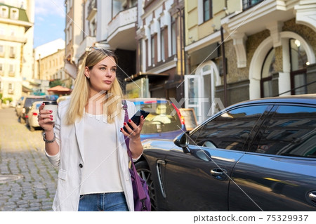 City portrait of young beautiful business woman walking down the street 75329937