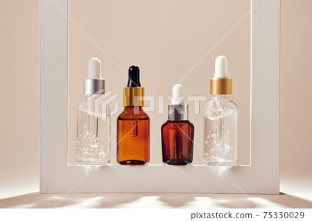 Anti-age cosmetic. Skincare collagen serum bottles. Neutral backgrounds and hard shadows 75330029