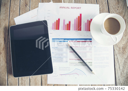 Office laptop business financial document chart and graph on wooden table with coffee cup. Flat lay notebook computer laptop on office desk. No people business graph chart mockup on business workspace Office laptop business financial document chart and graph on wooden table with coffee cup. Flat lay notebook computer laptop on office desk. No people business graph chart mockup on business workspace 75330142