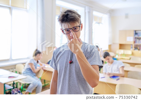 Smart teenager student male taking exam, answers lesson 75330742