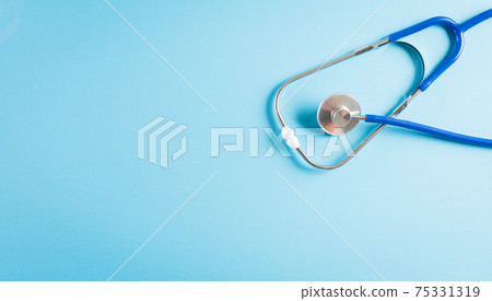 World health day and medical concept. Top view of doctor stethoscope on pastel blue background. 75331319