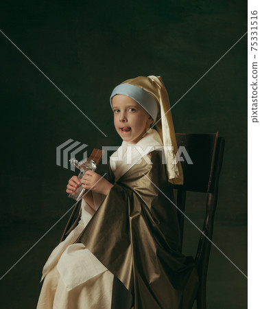 Medieval little girl as a lady with a pearl earring on dark studio background. Concept of comparison of eras, childhood. Stylish creative design, art vision, new look of artwork. Medieval little girl as a lady with a pearl earring on dark studio background. Concept of comparison of eras, childhood. Stylish creative design, art vision, new look of artwork. 75331516