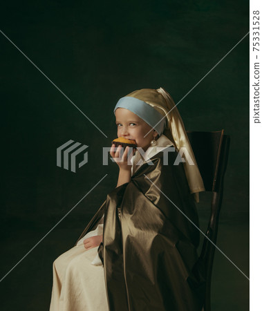 Medieval little girl as a lady with a pearl earring on dark studio background. Concept of comparison of eras, childhood. Stylish creative design, art vision, new look of artwork. 75331528