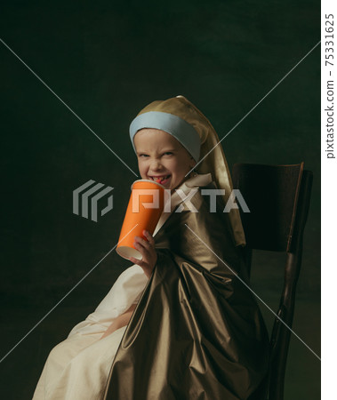 Medieval little girl as a lady with a pearl earring on dark studio background. Concept of comparison of eras, childhood. Stylish creative design, art vision, new look of artwork. 75331625