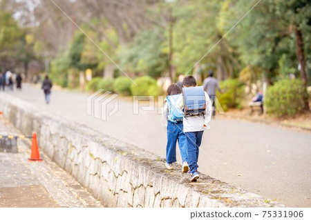 Brother and sister park school bag walking 75331906