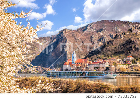 Durnstein village during spring time with tourist ship on Danube river in Wachau, Austria Durnstein village during spring time with tourist ship on Danube river in Wachau, Austria 75333752