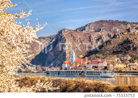 Durnstein village during spring time with tourist ship on Danube river in Wachau, Austria Durnstein village during spring time with tourist ship on Danube river in Wachau, Austria 75333753