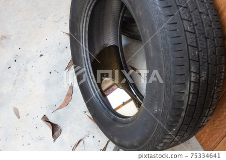 Old abandoned tyre with still water from rain condusive place for aedes mosquito breeding. Selective focus on water. 75334641