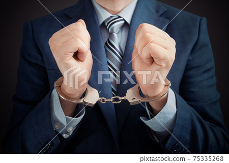 Businessman arrested, man in suit with handcuffs Businessman arrested, man in suit with handcuffs 75335268