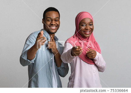 Charismatic black man and woman indicating at camera Charismatic black man and woman indicating at camera 75336664