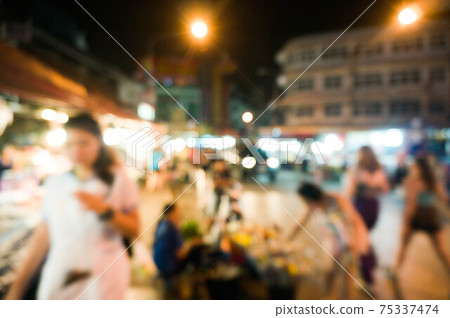 abstract blur image of food stall at night market festival for background usage 75337474