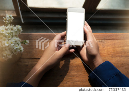 Women's hands holding cell telephone blank copy space screen. smart phone with technology concept. 75337483