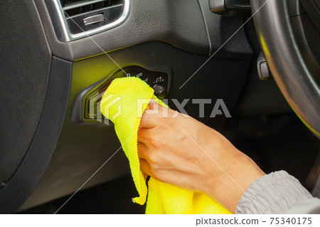 Hand with microfiber cloth cleaning Interior modern car. Hand with microfiber cloth cleaning Interior modern car. 75340175