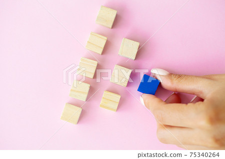 Woman hand putting and stacking blank wooden cubes on desk with copy space for input wording and infographic icon. Woman hand putting and stacking blank wooden cubes on desk with copy space for input wording and infographic icon. 75340264