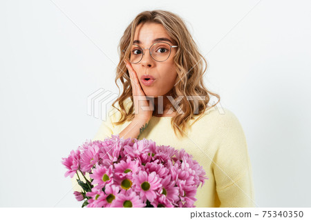 Portrait of surprised young woman with bouquet Portrait of surprised young woman with bouquet 75340350