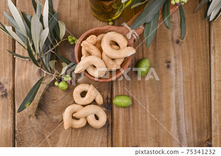 Taralli is a traditional Italian snack food typical of Puglia regional cuisine. Tarallini with fresh Taralli is a traditional Italian snack food typical of Puglia regional cuisine. Tarallini with fresh 75341232