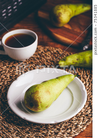 Green Pear on White Plate Green Pear on White Plate 75341885