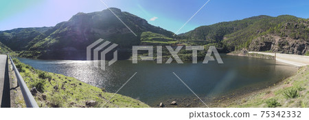 Panoramic view of sweet water dam Presa de Los Perez lake in Tamadaba nature park. Gran Canaria, Canary Islands, Spain Panoramic view of sweet water dam Presa de Los Perez lake in Tamadaba nature park. Gran Canaria, Canary Islands, Spain 75342332