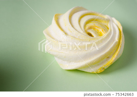 Homemade sweet colored meringue on green background. .Dessert. Close up meringue photo Homemade sweet colored meringue on green background. .Dessert. Close up meringue photo 75342663