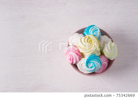 Homemade sweet colored meringue on white background. .Dessert. Homemade sweet colored meringue on white background. .Dessert. 75342669