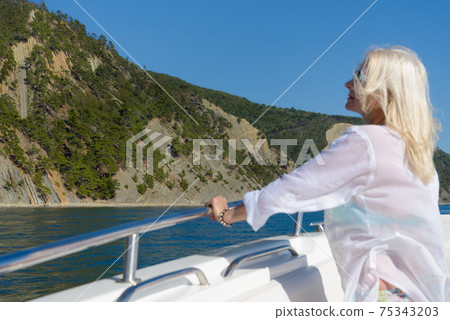 Blonde poses on a white yacht Blonde poses on a white yacht 75343203