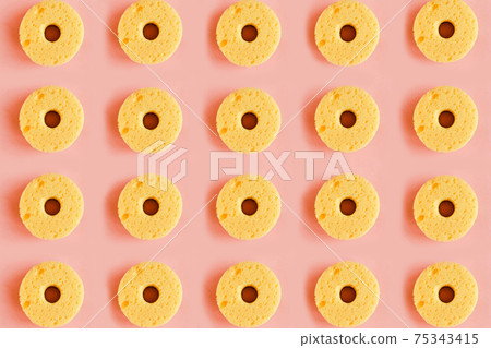 Seamless pattern of yellow sponges for washing dishes on pink background. Minimal concept Seamless pattern of yellow sponges for washing dishes on pink background. Minimal concept 75343415