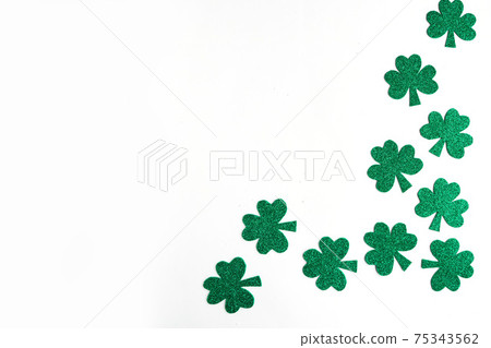 St. Patrick's Day side border paper shamrocks on white background. Copy space for the text St. Patrick's Day side border paper shamrocks on white background. Copy space for the text 75343562